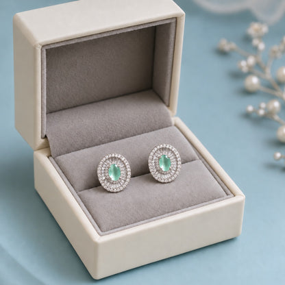 Crownline Oval Studs featuring a faceted oval mint green centre crystal framed by baguette-cut and round clear zircon stones in a polished silver-tone setting.