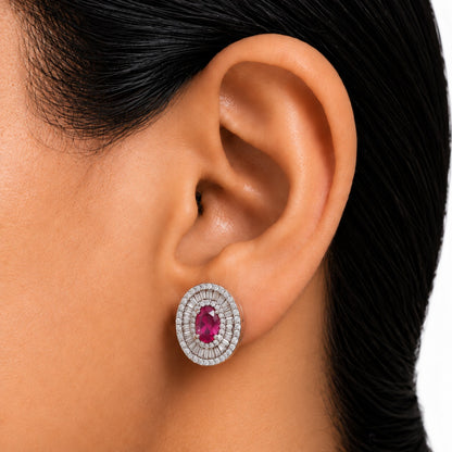 Close-up of Crownline Oval Stud earring worn on the ear, featuring a faceted centre crystal surrounded by layered clear zircon detailing