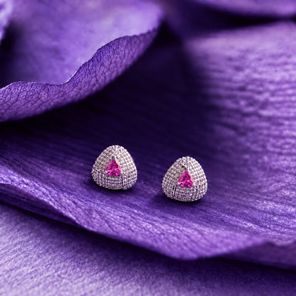 Close-up ear view wearing a triangular  pink tone stud with sparkling clear zircon detailing and a polished silver-tone finish. 