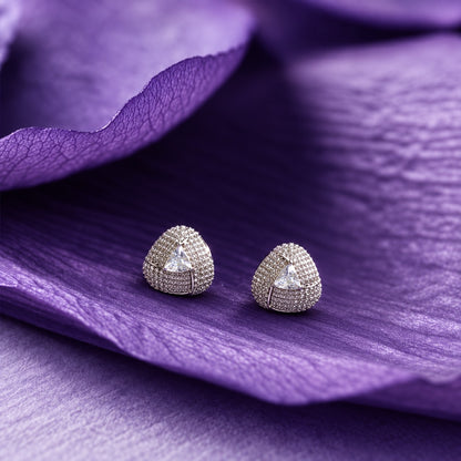 Close-up ear view wearing a triangular clear stone stud with sparkling clear zircon detailing and a polished silver-tone finish.
