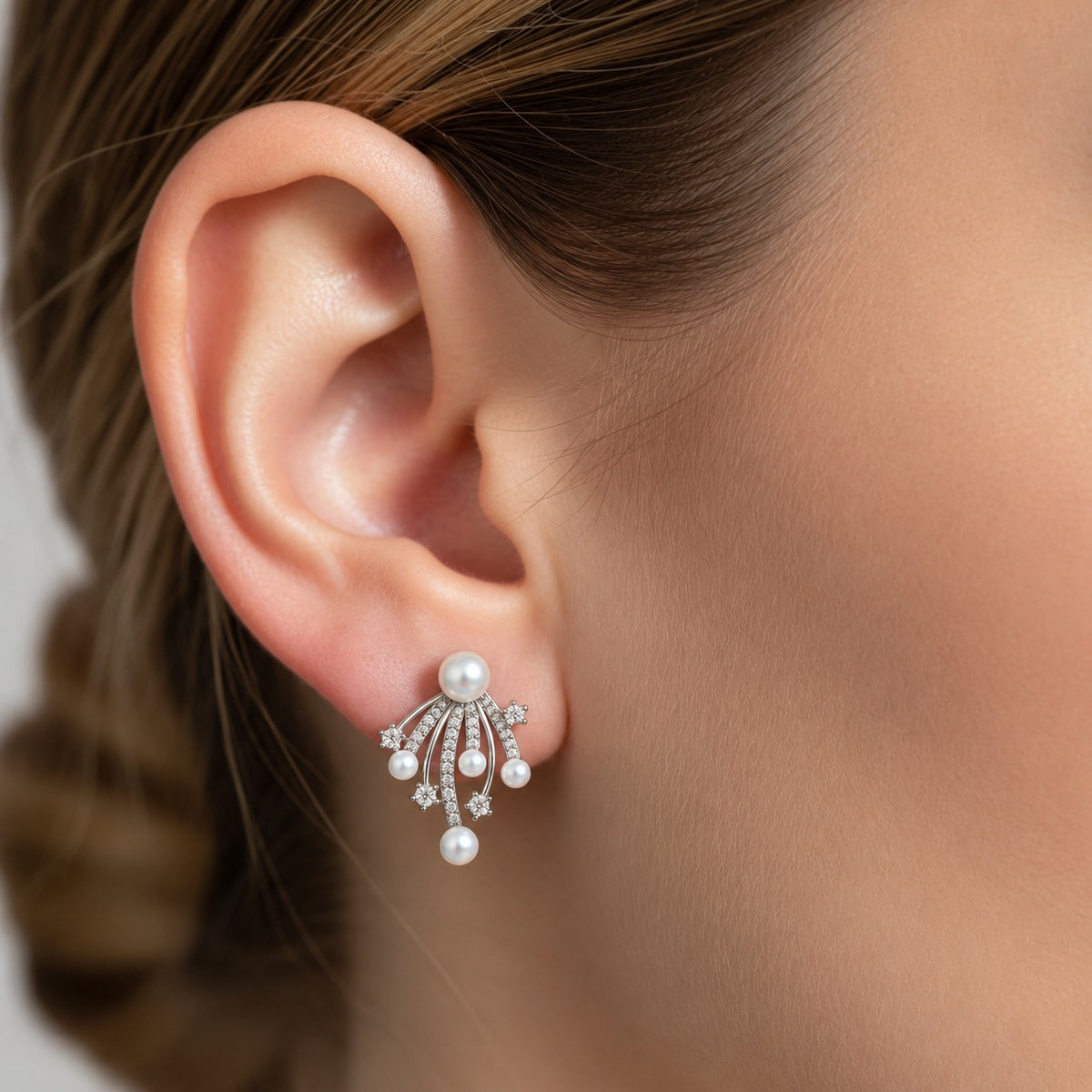 Close-up of Pearl drift Stud Earring worn on the ear, featuring cascading white pearls and sparkling zircon details in a silver-tone setting.
