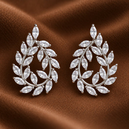Close up of silver Laurel Drop Earrings featuring marquise-cut clear zircon leaves arranged around an open teardrop-shaped silver-tone frame.