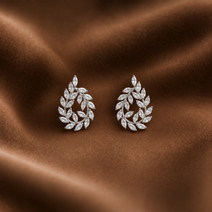 Silver Laurel Drop Earrings featuring marquise-cut clear zircon leaves arranged around an open teardrop-shaped silver-tone frame.