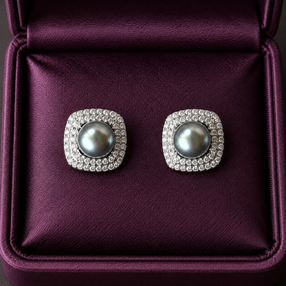 Smoky Crest Stud Earrings featuring grey pearl centres surrounded by double rows of clear zircon in softly squared silver-tone frames.