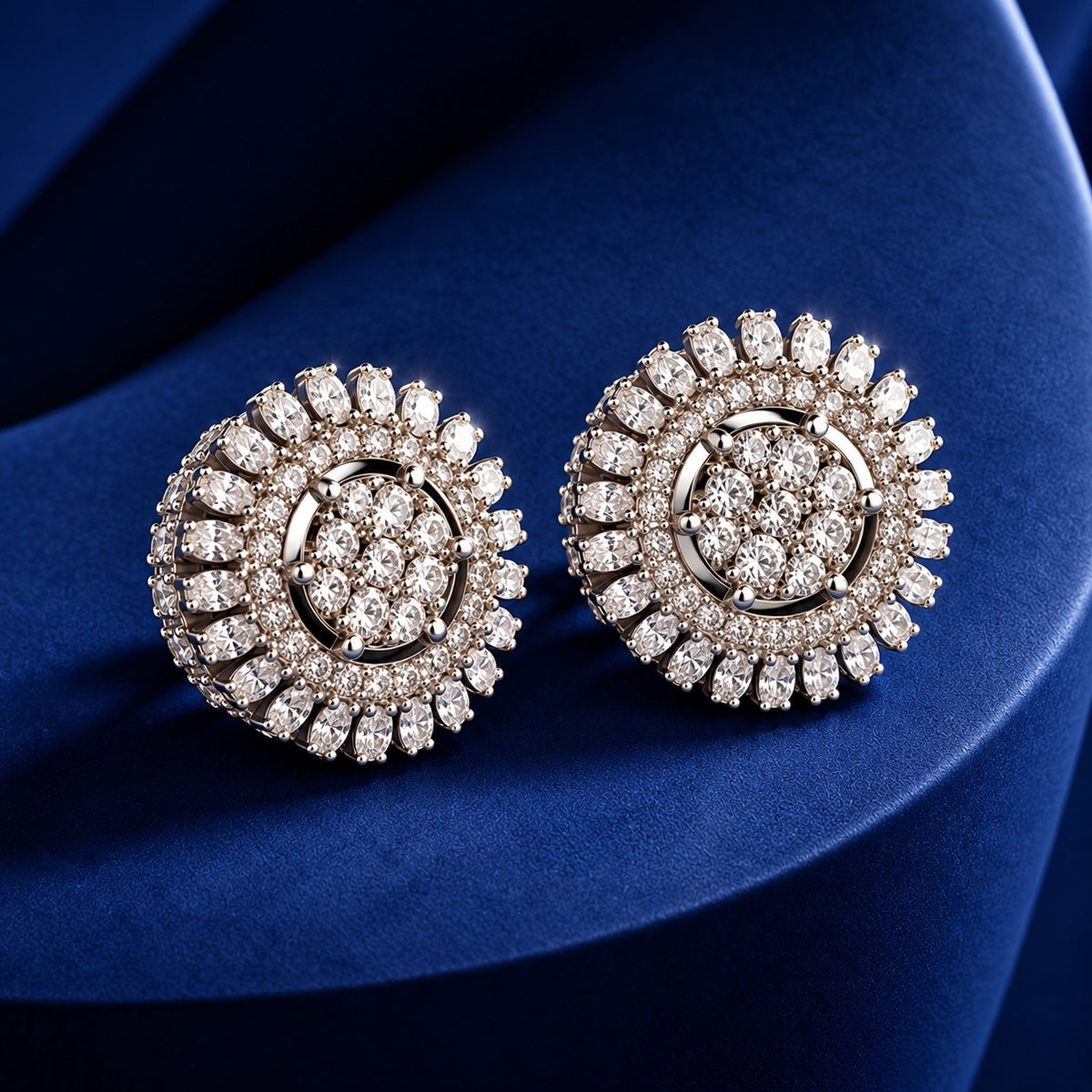 Celestial Wheel Stud Earrings featuring a circular silver-tone design with clustered clear zircon centres and radiating marquise-cut zircon detailing