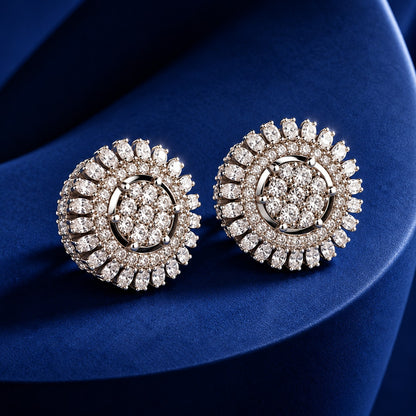 Celestial Wheel Stud Earrings featuring a circular silver-tone design with clustered clear zircon centres and radiating marquise-cut zircon detailing