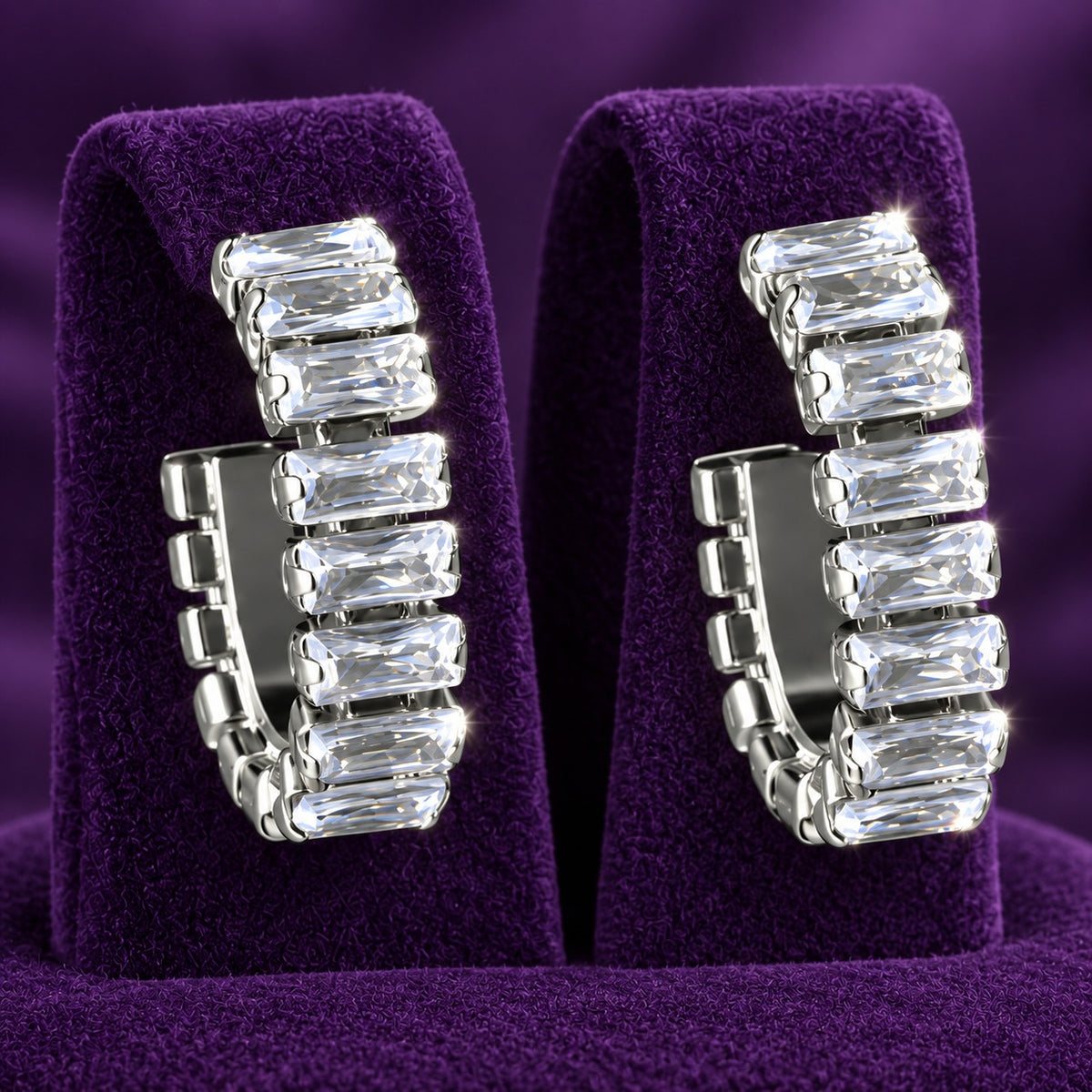 Close-up of geometric hoop earrings featuring individually set rectangular clear zircon stones in silver