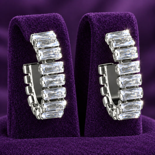 Close-up of geometric hoop earrings featuring individually set rectangular clear zircon stones in silver