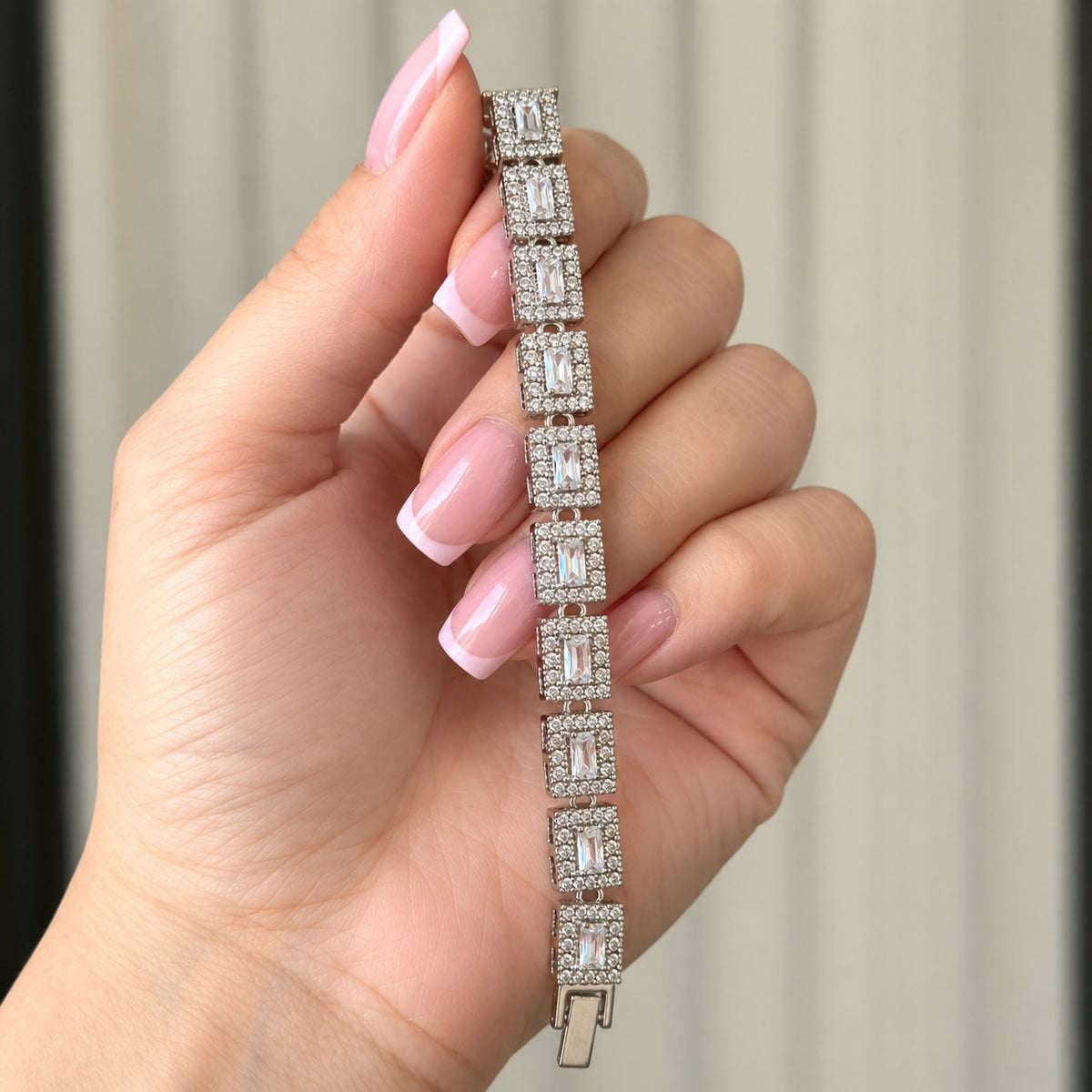 Detailed view of the silver-tone Framed Link Bracelet showing its articulated rectangular settings and polished box-style clasp.