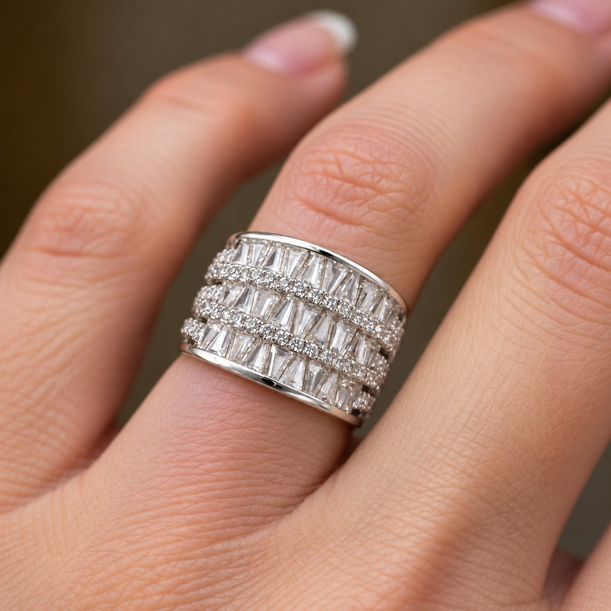Close-up of the Tierline S925 sterling silver statement ring worn on the finger, showing its broad three-tier zircon design and polished silver finish.