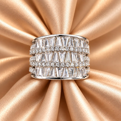 Front close-up of the S925 sterling silver Tierline Ring on champagne satin, showing its wide multi-row design with tapered and round clear zircon.
