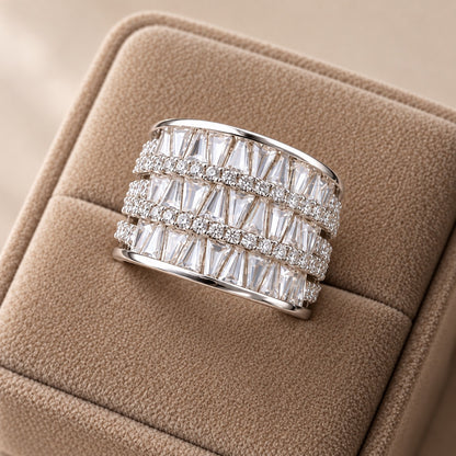 S925 sterling silver Tierline Ring displayed in a beige velvet jewellery box, featuring three rows of tapered clear zircon separated by fine rows of round zircon.