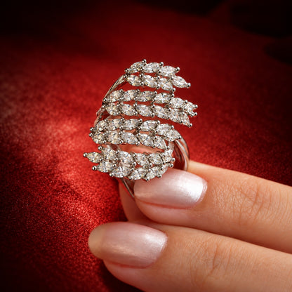 Close-up of the Silver Laurel Statement Ring held between the fingers, featuring layered rows of marquise-cut clear zircon in a polished S925 sterling silver setting.