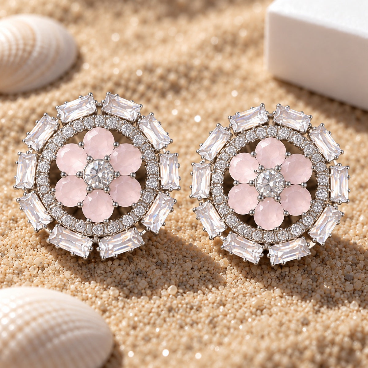 Blush pink floral stud earrings featuring six soft pink gemstone petals, a clear zircon centre and layered circular clear-stone border.