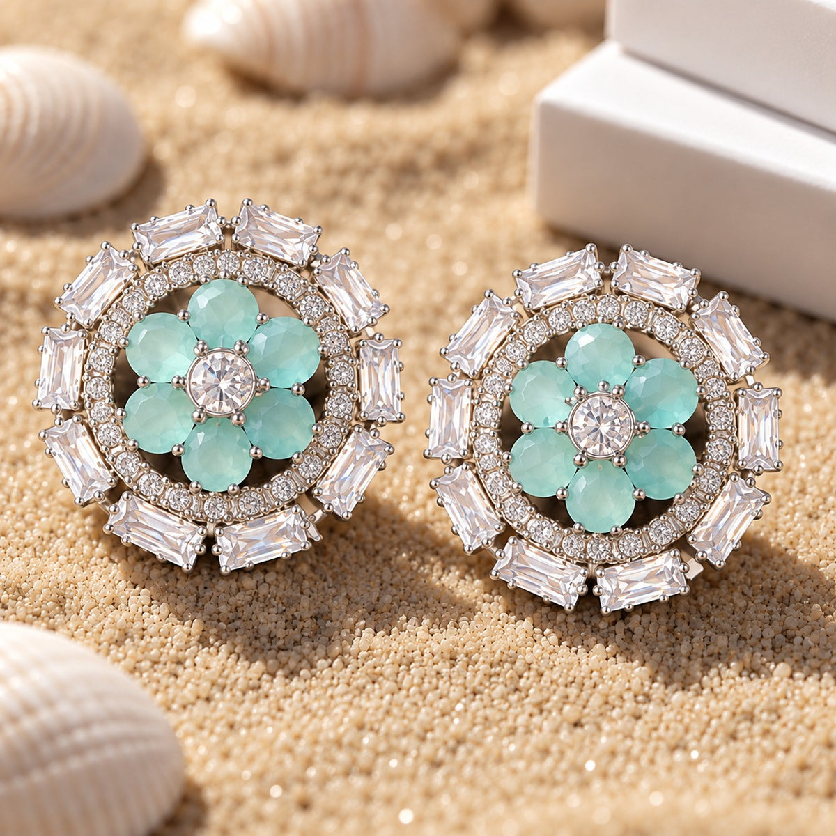Close-up of aqua blue Petal Orbit Stud Earring worn on the ear, featuring six gemstone petals surrounded by clear round zircon and rectangular clear stones.