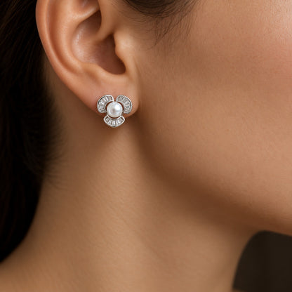 Close-up of a woman wearing a compact Pearl Arc Stud Earring with a white pearl centre and three curved silver-tone sections detailed with clear baguette stones