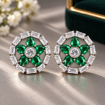 Petal Circuit Stud Earrings featuring five  emerald green pear-cut coloured gemstone petals, a round clear zircon centre and a circular border of clear baguette stones in silver-tone metal.