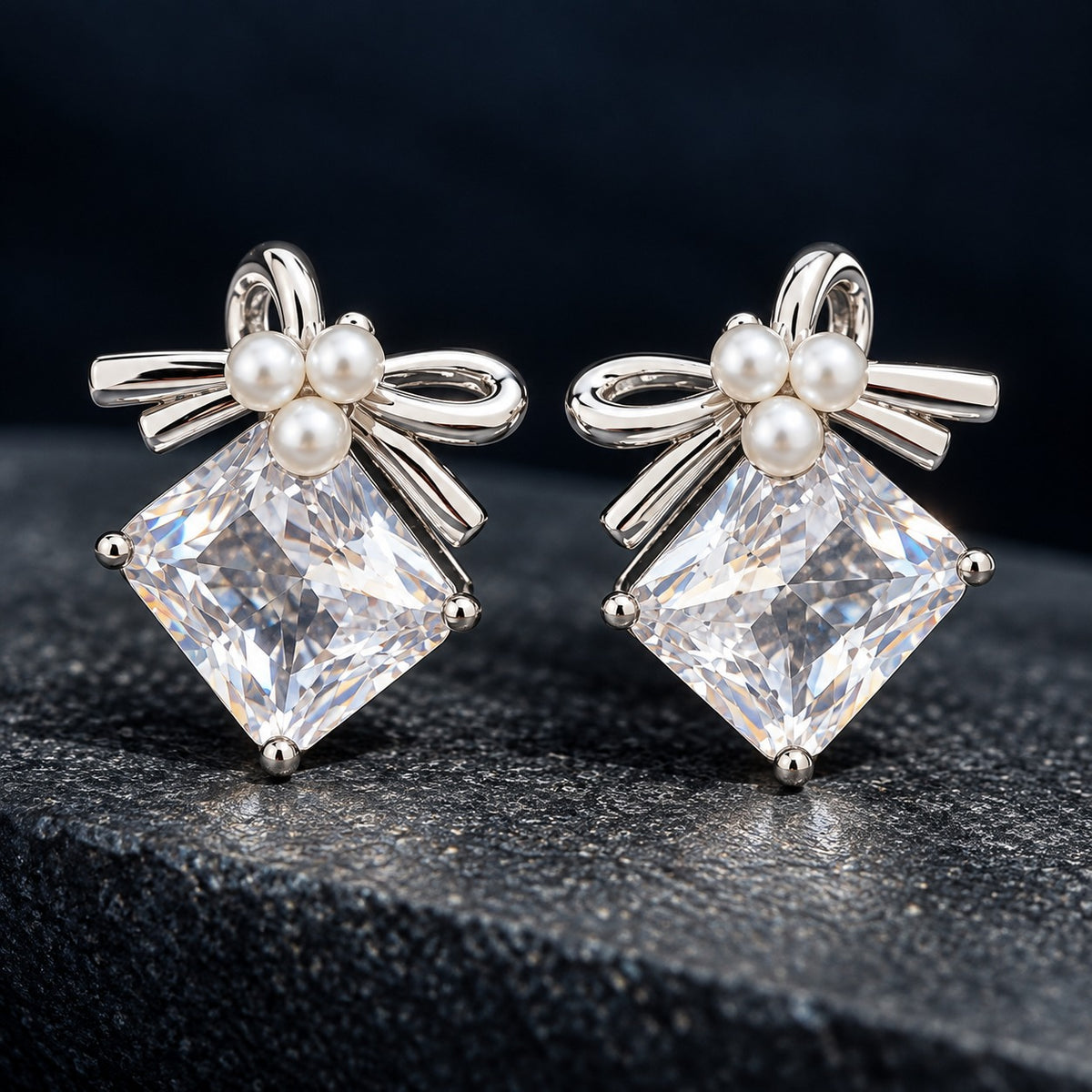 Close-up of Bowline Quartz Stud Earrings with clear diamond-shaped zircon stones, three white pearls and polished silver-tone bow detailing.