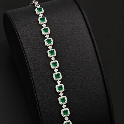 Silver-tone Regal Grid Bracelet featuring square-cut  green gemstones surrounded by clear zircon borders and connected with small diamond-shaped zircon links, available in ruby red, emerald green and clear zircon.