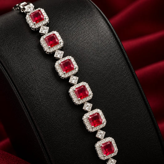 Silver-tone Regal Grid Bracelet featuring square-cut gemstones surrounded by clear zircon borders and connected with small diamond-shaped zircon links, available in ruby red, emerald green and clear zircon.