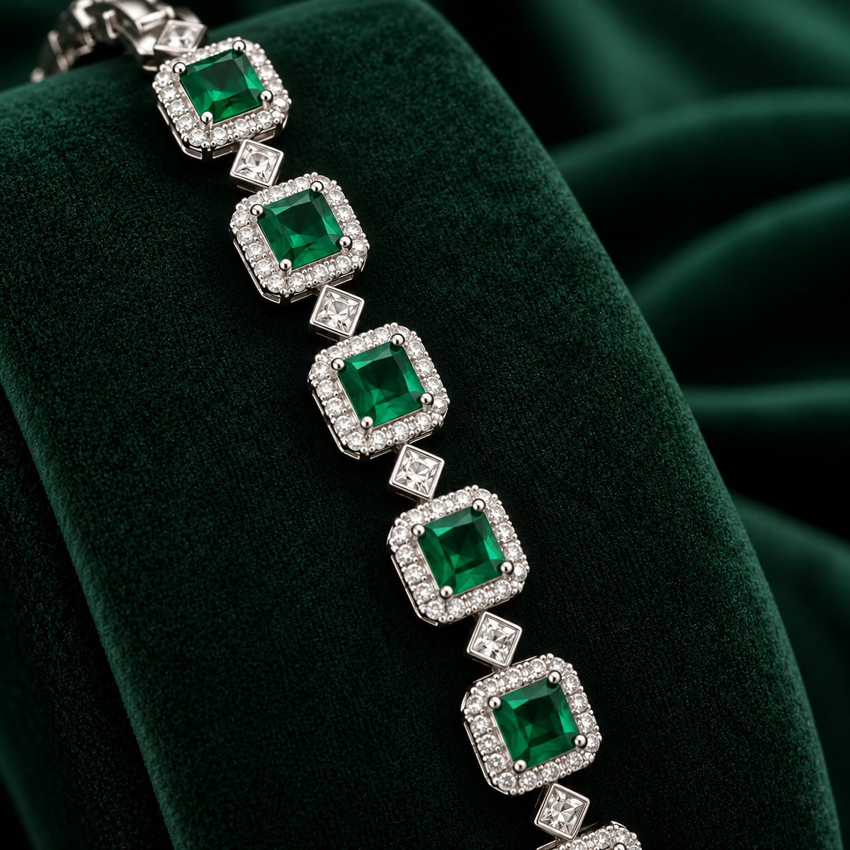 Silver-tone Regal Grid Bracelet featuring square-cut gemstones surrounded by clear zircon borders and connected with small diamond-shaped zircon links, available in ruby red, emerald green and clear zircon.