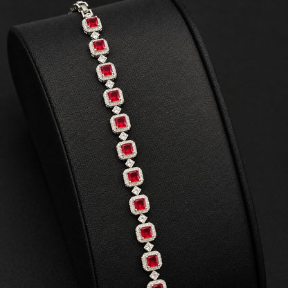 Silver-tone Regal Grid Bracelet featuring square-cut  red gemstones surrounded by clear zircon borders and connected with small diamond-shaped zircon links, available in ruby red, emerald green and clear zircon.