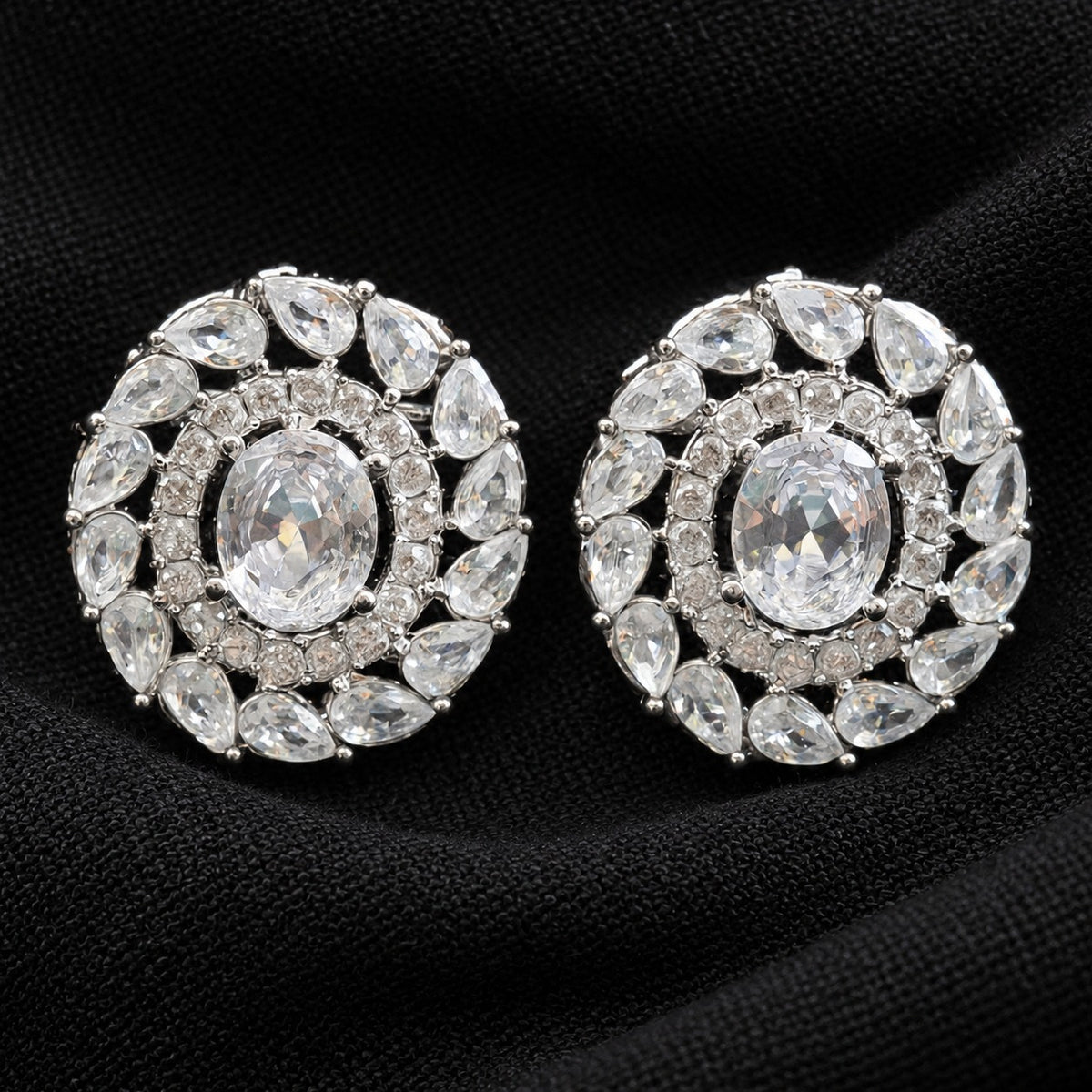 Detailed close-up of Regal Wreath Studs showing the oval  clear centre stone, inner zircon border and outer ring of pear-cut clear stones.