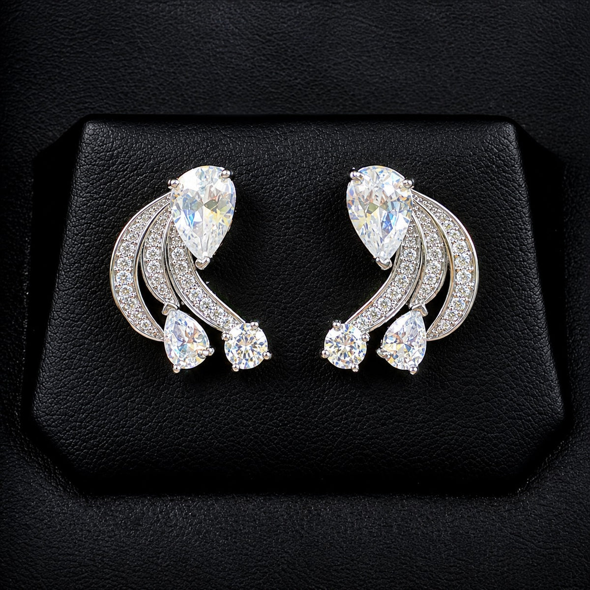 Pair of Angelique Wing Studs in silver-tone metal with sweeping zircon-lined curves and pear and round-cut stones.