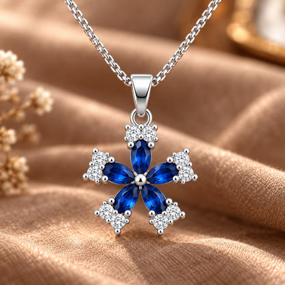 Fleur Quintet Locket featuring deep sapphire-blue marquise stones with clear zircon clusters.