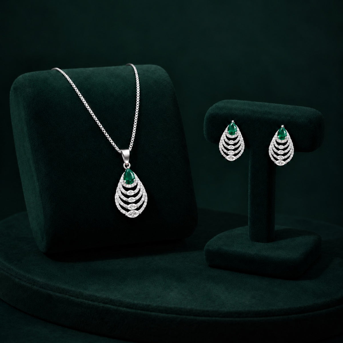 Cascade Leaf pendant and earrings with emerald green pear-cut stones and clear zircons.