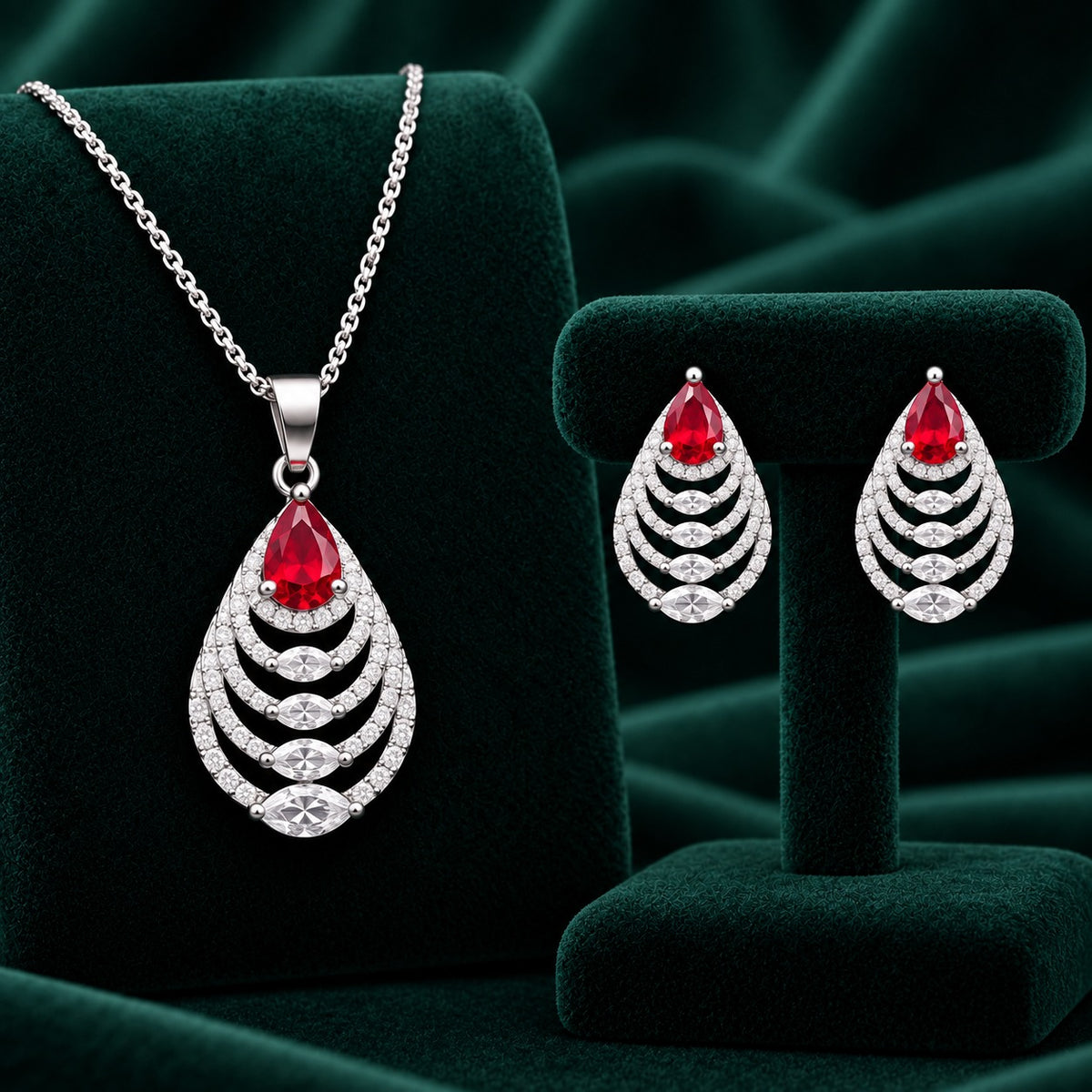 Cascade Leaf jewellery set featuring ruby red pear-cut stones with clear zircon detailing.