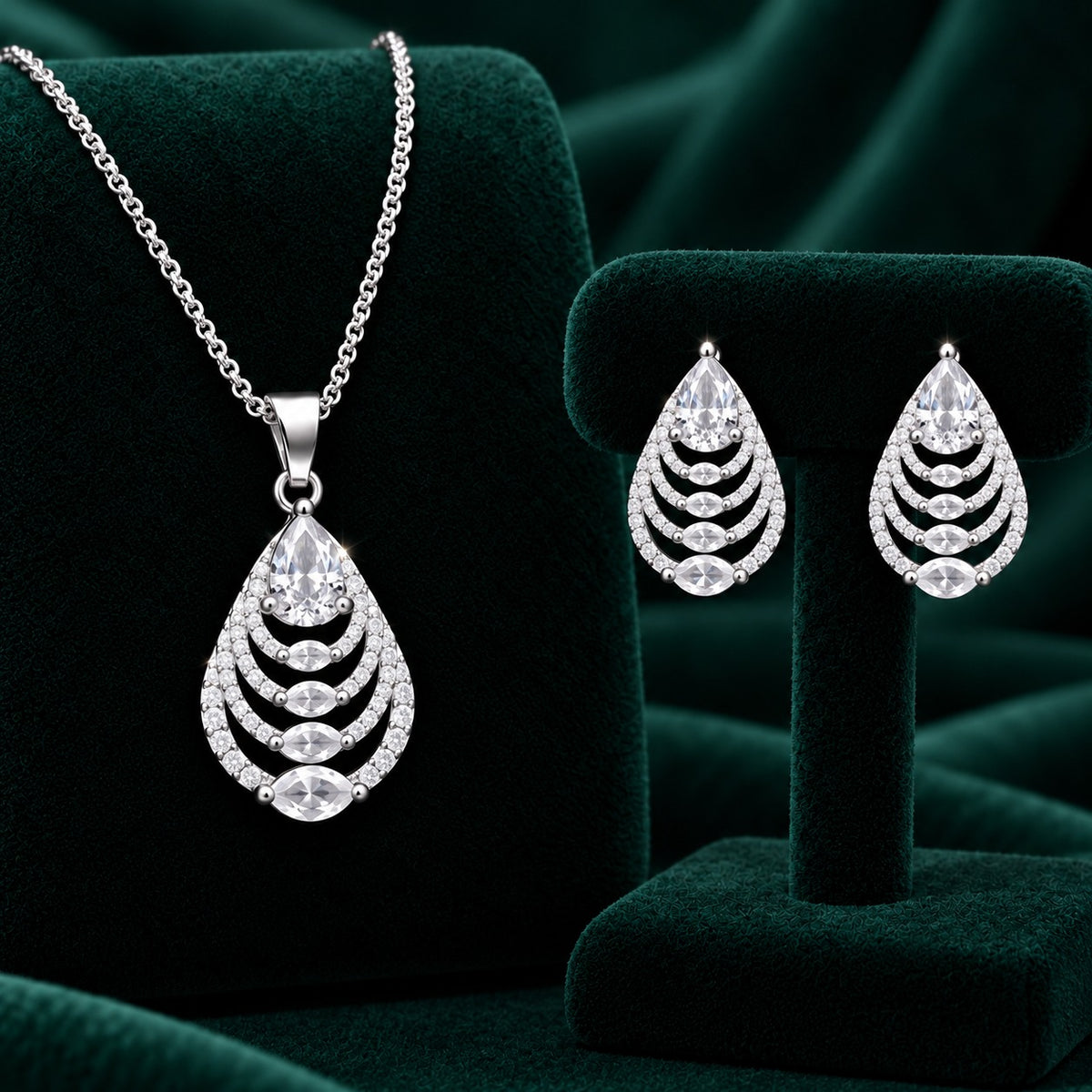 Clear zircon Cascade Leaf pendant and matching earrings in polished silver tone.