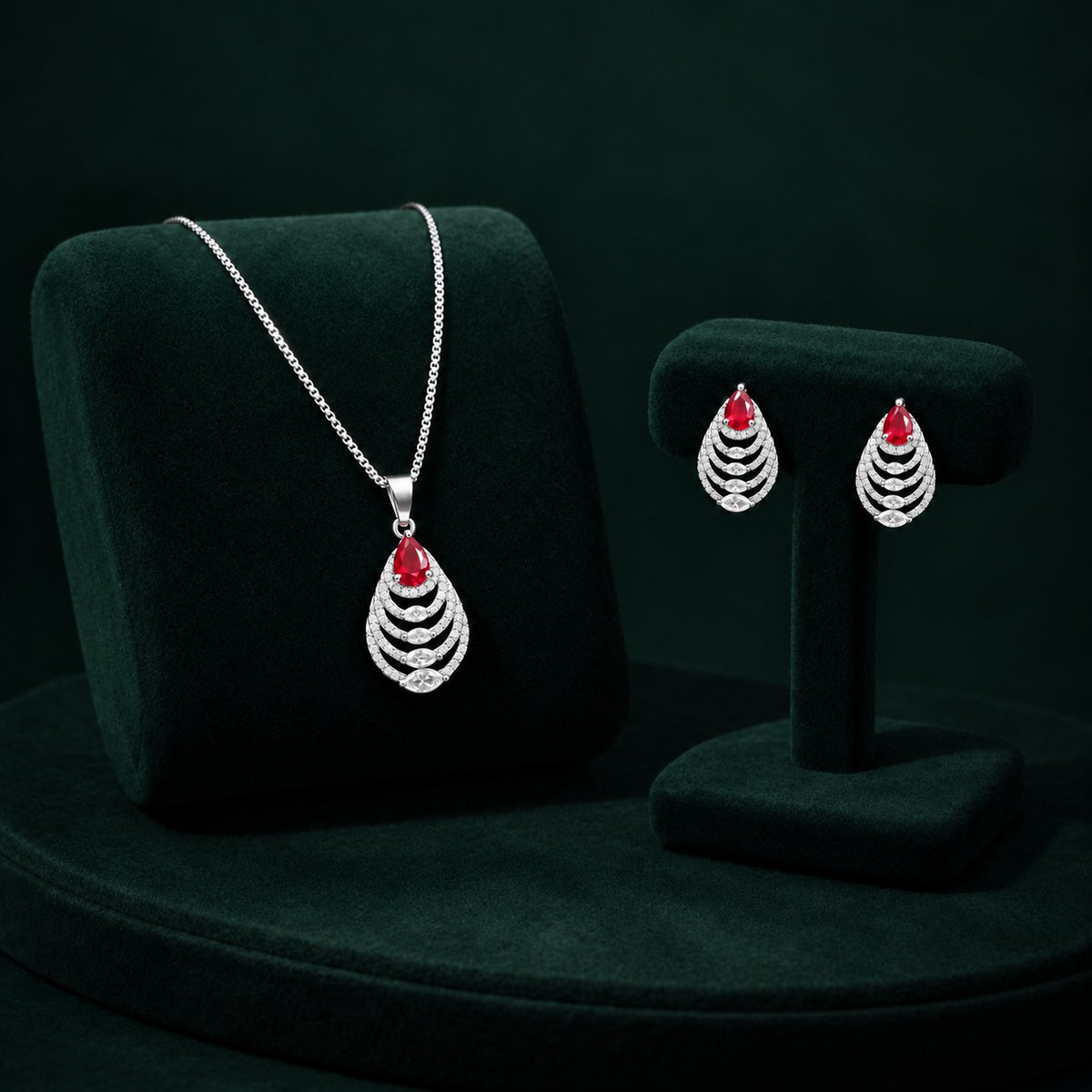 Cascade Leaf jewellery set featuring ruby red pear-cut stones with clear zircon detailing.