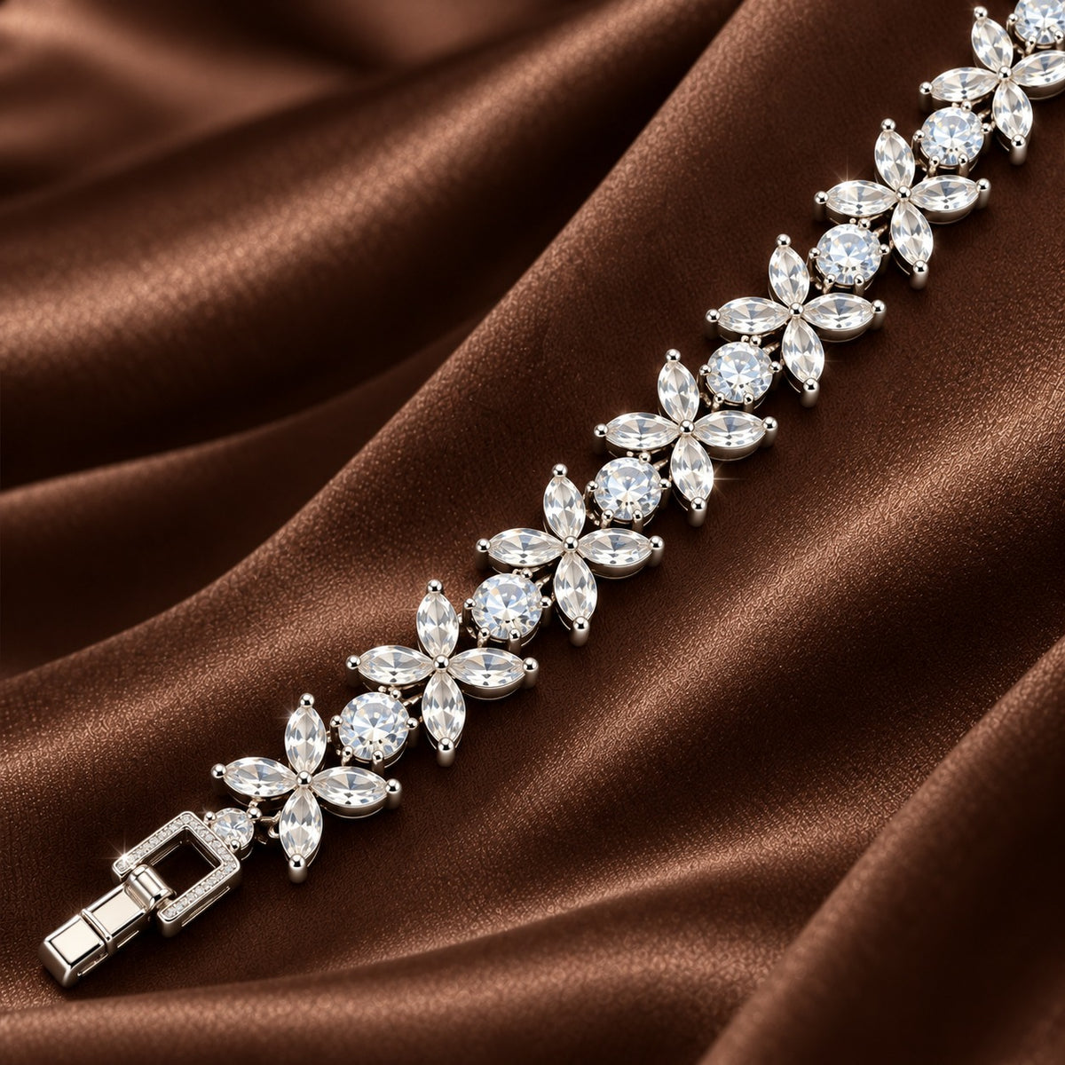 Close-up of silver-tone bracelet featuring four-petal marquise zircon flowers alternating with round clear zircon stones.