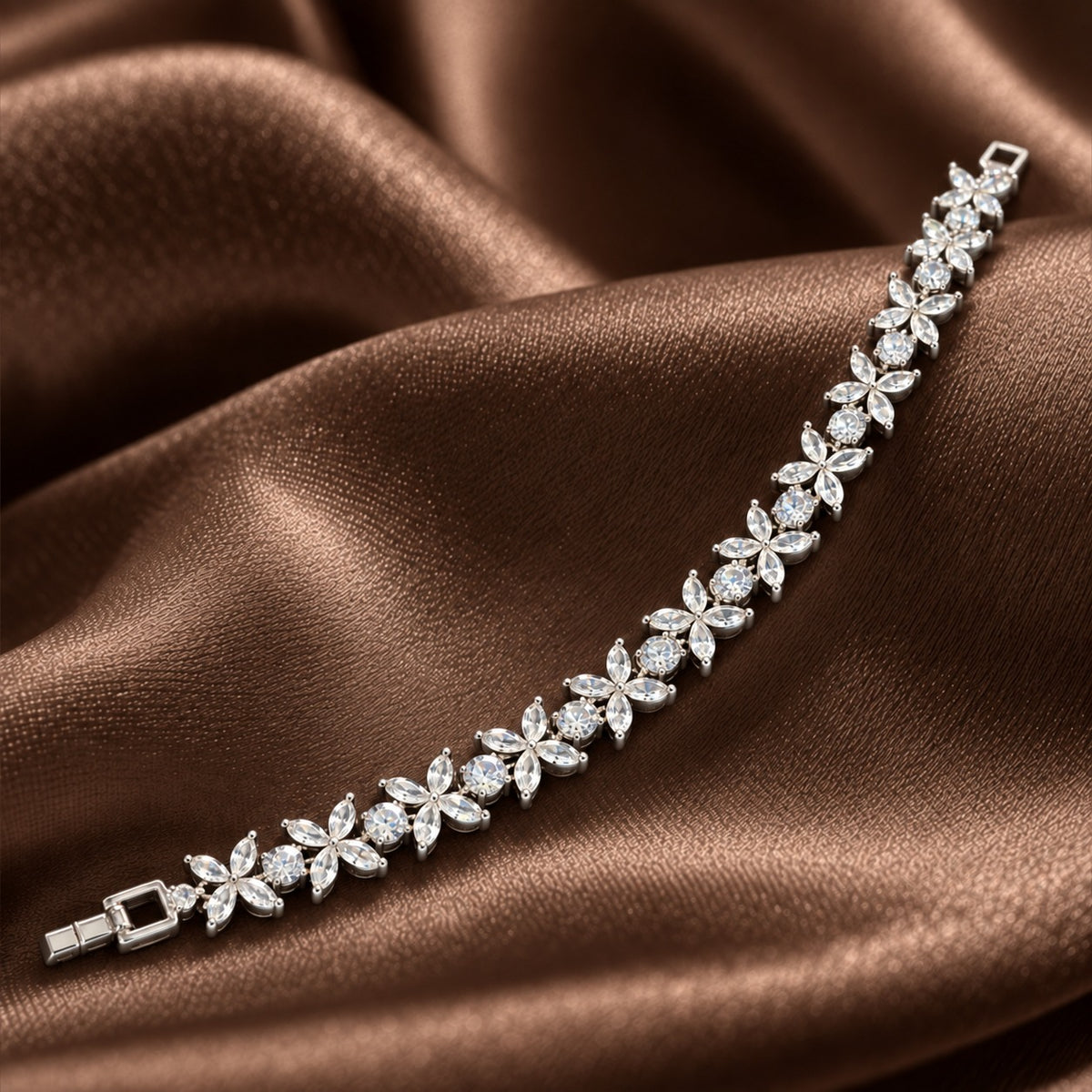 Silver Marquise Fleur Bracelet with clear zircon flowers and round stones displayed on rich brown satin.