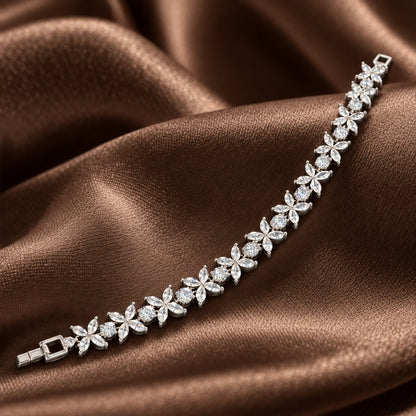 Silver Marquise Fleur Bracelet with clear zircon flowers and round stones displayed on rich brown satin.