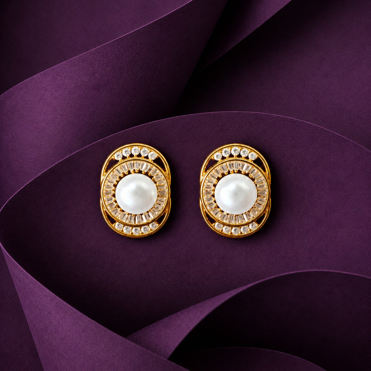 view of Pearl Meridian Studs showing the polished oval framework, pearl centre and clear zircon arrangement.