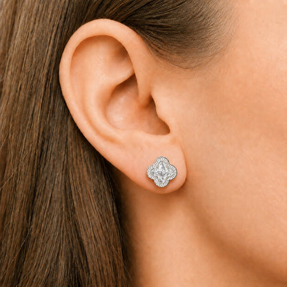 Close-up of an ear wearing an S925 sterling silver quatrefoil stud with a clear faceted centre stone and zircon detailing.