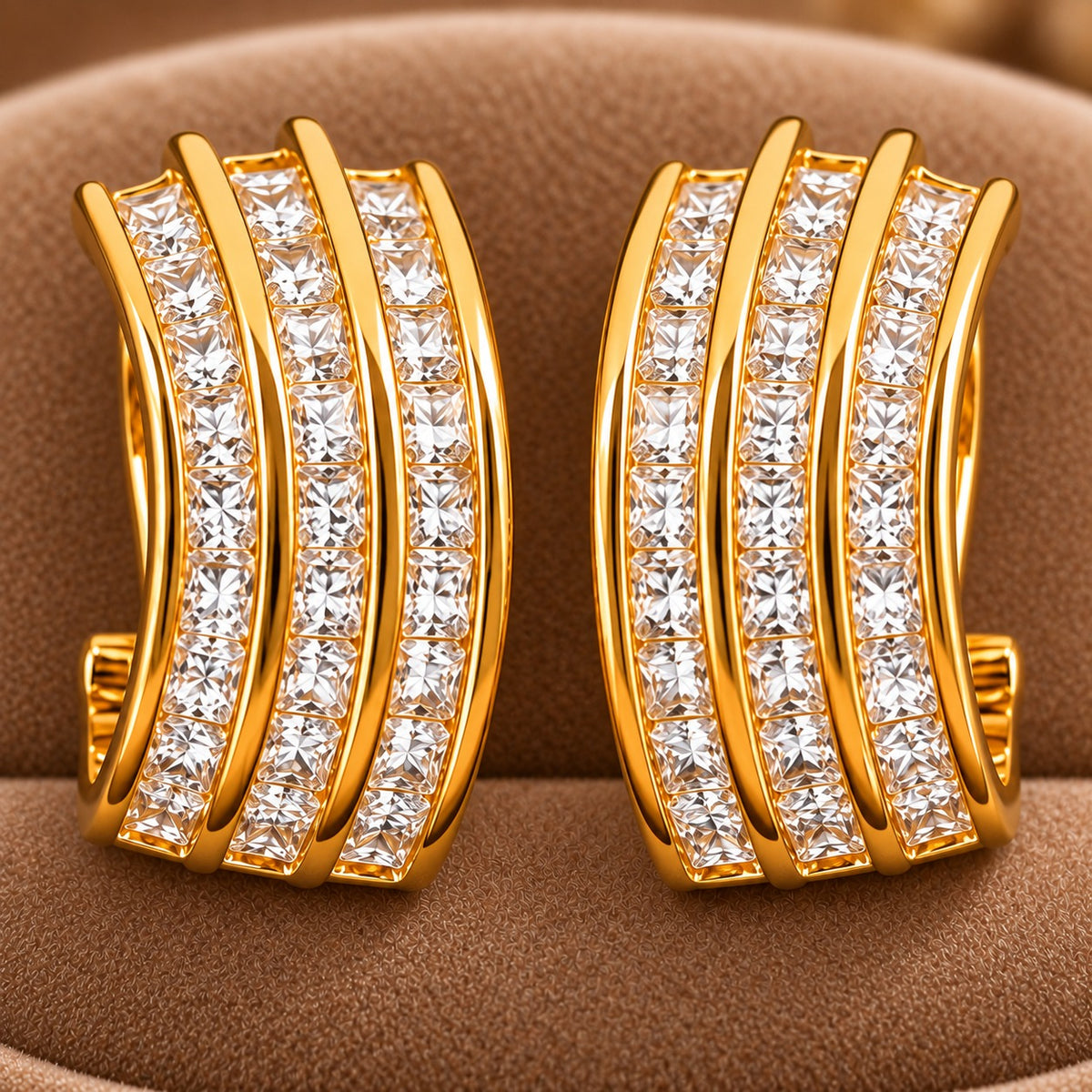 Close-up of Gilded Trio Arc Hoops showing three parallel gold curves with precisely arranged clear square-cut zircons.