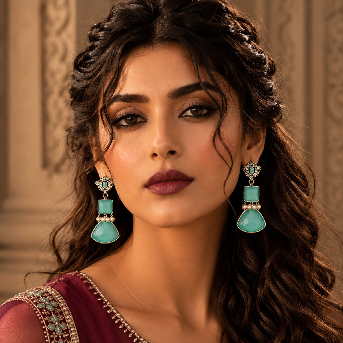 Model wearing mint green Heirloom Crest Drops with a maroon  embellished outfit.