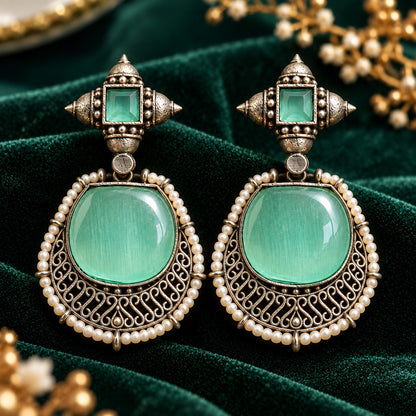 The Ancestral Crest Drops in Mint green with antique silver filigree and pearl detailing