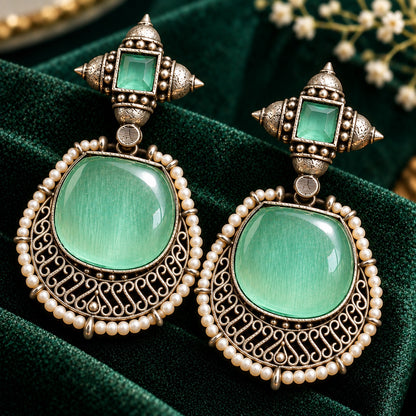 The Ancestral Crest Drops in Mint green with antique silver filigree and pearl detailing. 