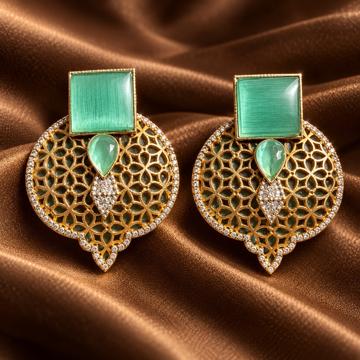 Mint green Sovereign Court Earrings featuring contrasting geometric stones, ornate gold-tone detailing and a clear zircon-edged frame