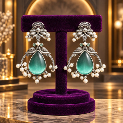 The Royal Treasury Earrings in Aqua Teal with teardrop centre stones, pearl-like clusters and antique oxidised silver-tone detailing.