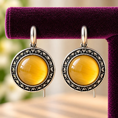 Close-up of Golden Amber Ottoman Round Earrings showing smooth domed stones and intricate geometric antique-metal detailing.
