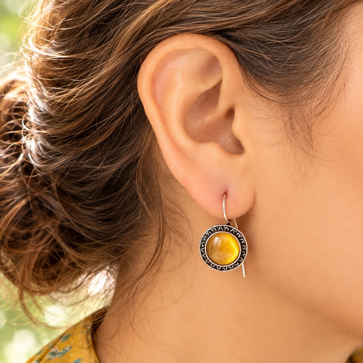 Model wearing Golden Amber Ottoman Round Earrings, showing their circular drop silhouette and natural proportion on the ear.