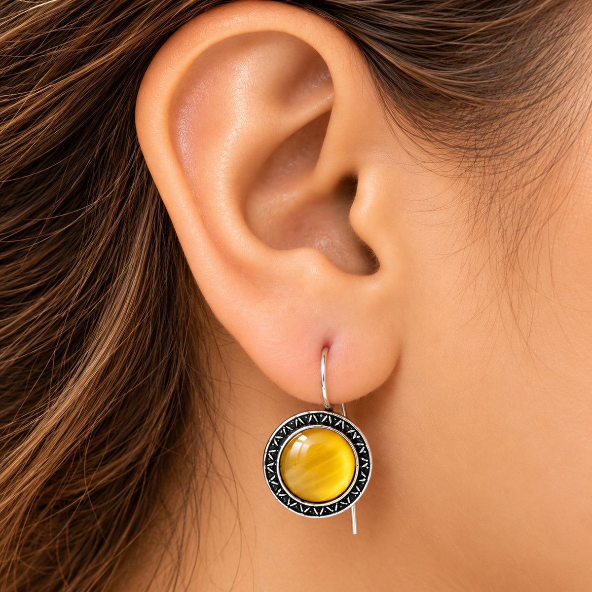 Model wearing Golden Amber Ottoman Round Earrings, showing their circular drop silhouette and natural proportion on the ear.