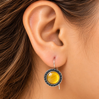 Model wearing Golden Amber Ottoman Round Earrings, showing their circular drop silhouette and natural proportion on the ear.