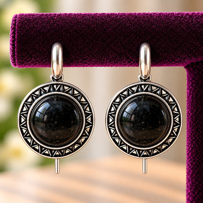 Close-up of Onyx Black Ottoman Round Earrings showing smooth domed stones and intricate geometric antique-metal detailing
