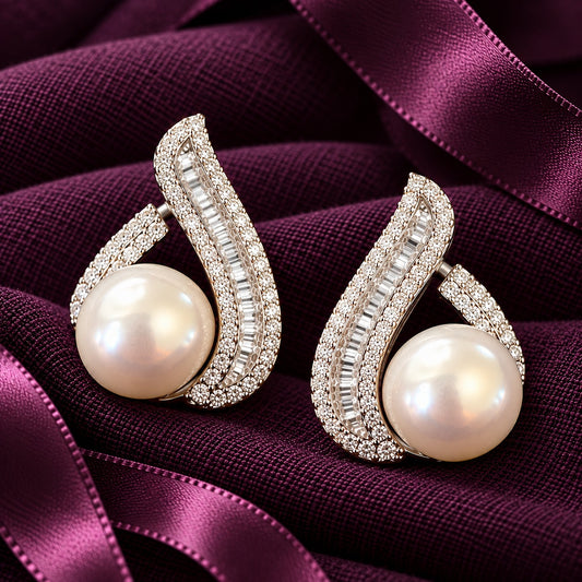 Close-up of S925 Pearl Plume Earrings showing the pearl centrepiece, baguette zircon detailing and curved silver design.